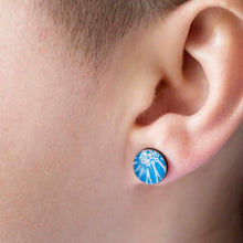 Load image into Gallery viewer, A close up of a blue stud earring being worn, handmade by Dittany Rose in Cambridge, UK from paper, sterling silver and resin