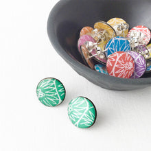 Load image into Gallery viewer, A green pair of large stud earrings handmade from silver, paper and resin by Dittany Rose
