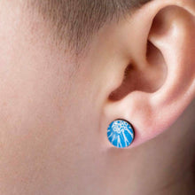 Load image into Gallery viewer, A close up of a blue stud earring being worn, handmade by Dittany Rose in Cambridge, UK from paper, sterling silver and resin
